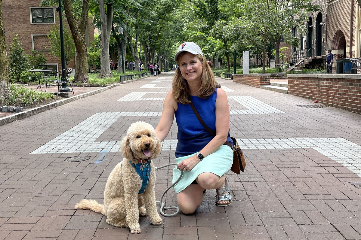 President Magill with her dog, Olive, on Locust Walk