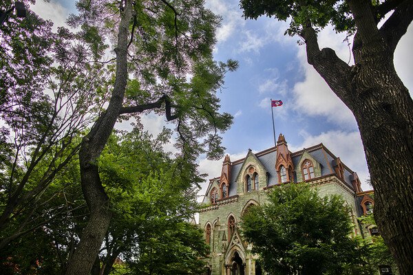 College Hall framed by mature trees in the late summer months